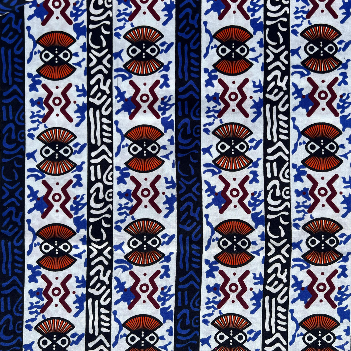 Stack of colorful original African Ankara cotton fabrics neatly folded, showcasing bold geometric wax print designs ideal for DIY sewing and patchwork quilting.